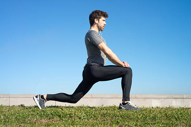 istock Man makes strechings before running in the grass 499905150