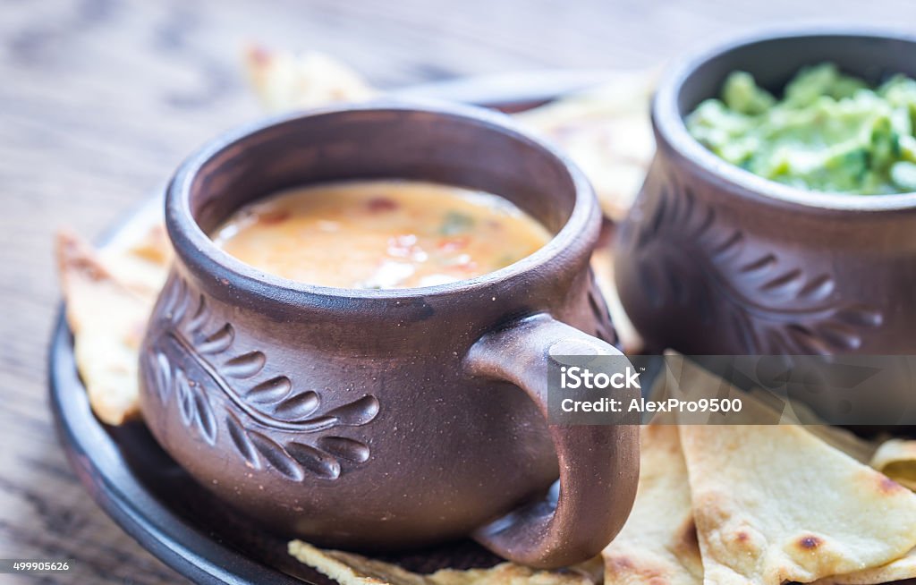 Bowls of guacamole and queso with tortilla chips Appetizer Stock Photo
