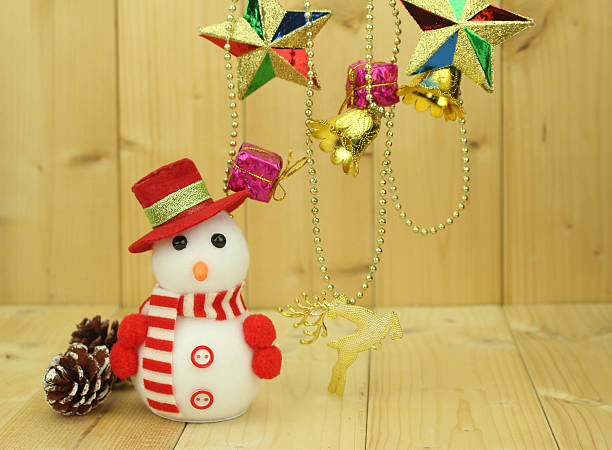 istock Toy snowman  is standing beside Christmas decoration 499907046