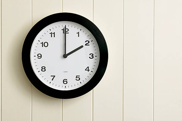 Clock on painted wood panel wall stock photo