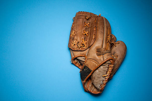 istock Worn Baseball Glove Againts Blue Background 499907819