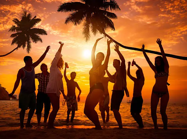 Photo of Group of Cheerful People Partying on a Beach