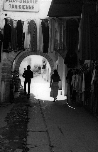 Man and woman walking trough the old city, Medina, Tunesia.