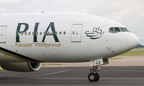 PIA Airlines Boeing 777 Manchester, United Kingdom - June 14, 2014: PIA Airlines Boeing 777 taxiing, Manchester International Airport. Prime Minister of Pakistan, Mr. Muhammad Nawaz Sharif, has expressed resolve to make PIA World's leading airline.  lahore pakistan photos stock pictures, royalty-free photos & images