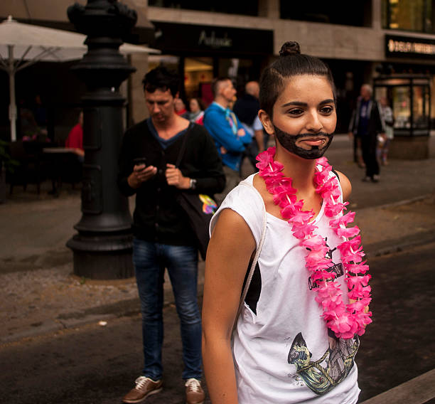 Berlin, Germany - June 21, 2014: Christopher Street Day.Crowd of people Participate in the parade celebrates gays, lesbians, bisexuals and transgenders.Prominent in the image a participant disguised as Conchita Wurst.