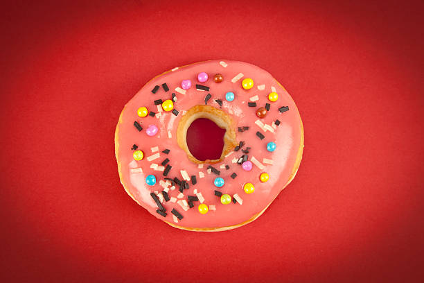 istock Colorful fresh doughnut on red background 499910237