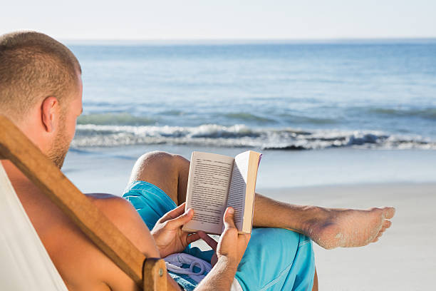 1,100+ Man Reading Book On Beach Stock Photos, Pictures & Royalty-Free ...