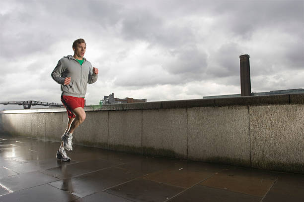 istock Young Man Jogging On Stormy Day 499911685