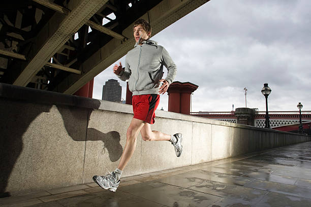 istock Young Man Jogging On Stormy Day 499911689