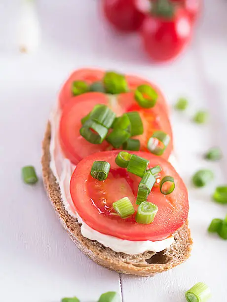 A slice of bread topped with tomatoes