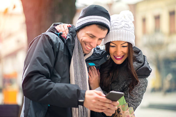 istock Couple Using Smart Phone On Street 499912764