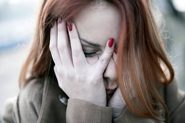 istock Scared woman hiding her face in hands 499913212