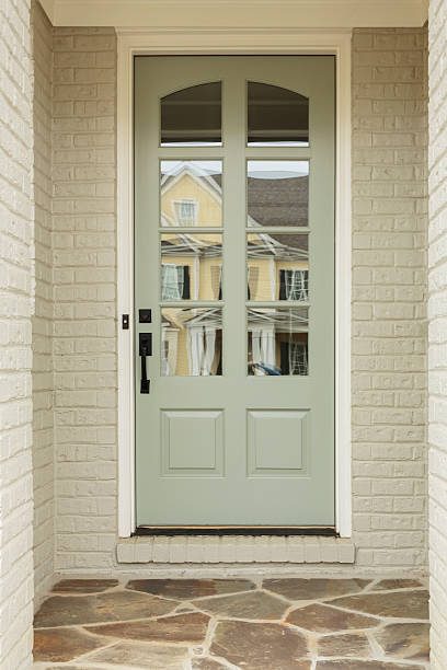 istock Light green front door to white brick home 499914795
