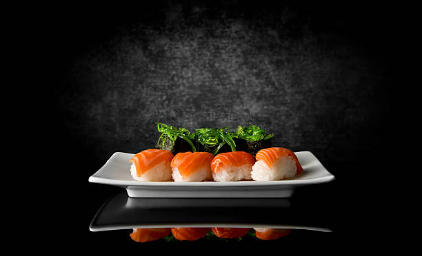 Sushi on black Sushi in plate on a black background japanese cuisine food rolled up japanese culture stock pictures, royalty-free photos & images