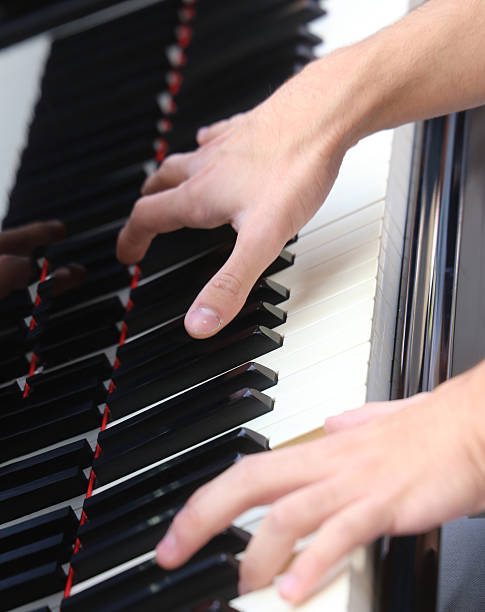 istock Young pianist hand while playing the piano 499925438