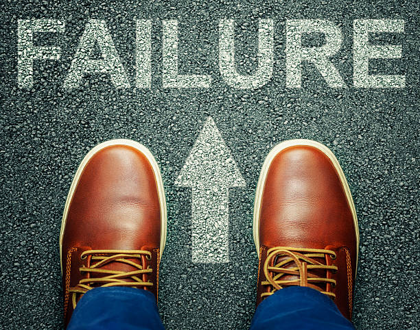 istock Man before inscription FAILURE on asphalt 499926322
