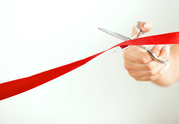 istock Woman using scissors to cut opening ribbon 499927754