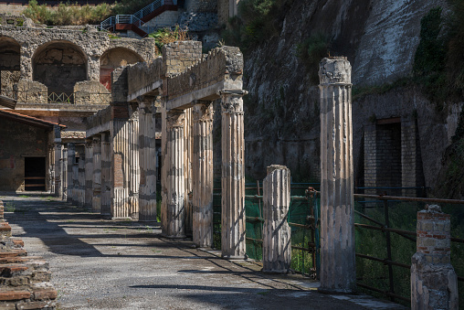 A row of columns in the Athletic Arena of the ruined town of Herculaneum, Italy.  Herculaneum was buried under sixty feet of ash twelve hours after the devastation of Pompeii in 79 A.D.