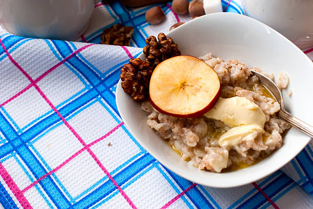 istock oatmeal with butter, berries and nuts for breakfast with tea 499931238