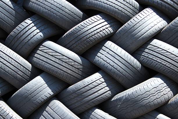 istock Stack of used car tires in the garage 499935768