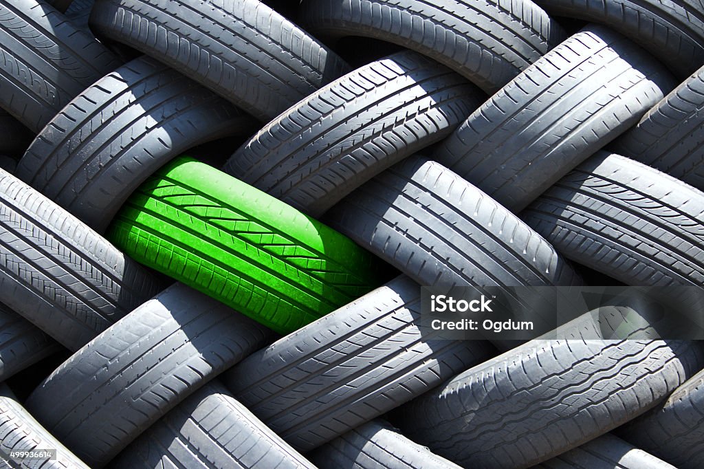 Green differs Single green tire in a stack of tires Tire - Vehicle Part Stock Photo