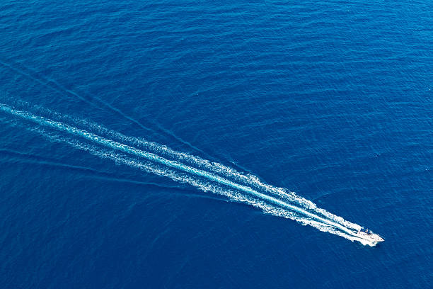 Boat surf foam aerial from prop wash in blue sea Boat surf foam aerial from prop wash in blue Majorca mediterranean sea sea wake stock pictures, royalty-free photos & images