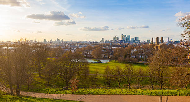 Panoramic view of London from Greenwich park at sunset Panoramic view of London from Greenwich park at sunset. Many famous buildings and skyscrapers of the city are easily recognisable on background. greenwich london stock pictures, royalty-free photos & images