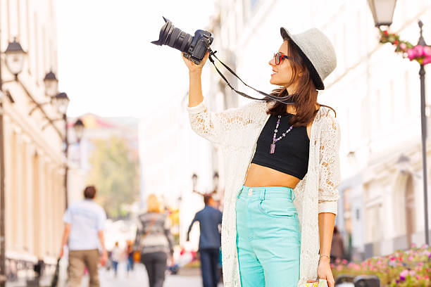 istock Girl wearing sunglasses shooting with camera 499954060