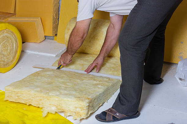 istock handyman cutting the termal insulation at the attic 499954294