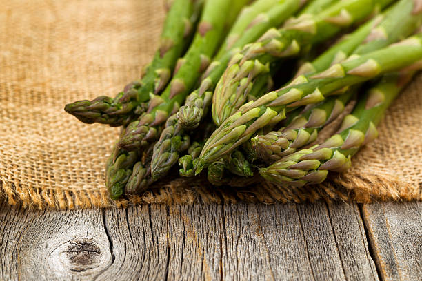 istock Fresh Asparagus on napkin and rustic wood 499956116