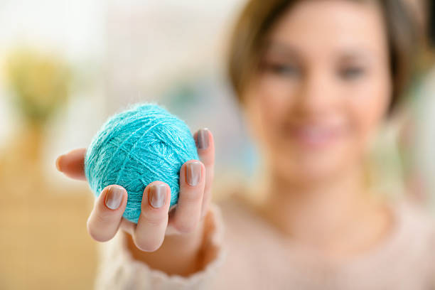 istock Young girl holding a wool yarn 499977890