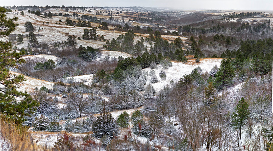 A soft snow covers the hills surrounding the river valley