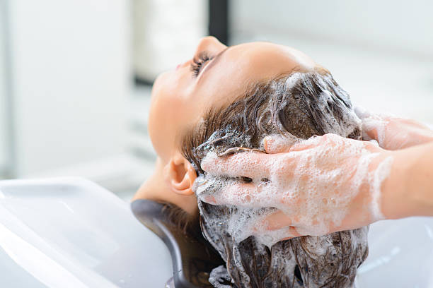 istock Stylist is washing clients hair 499979302