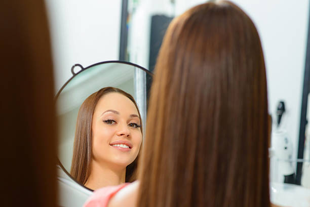 istock Client is admiring her new hairdo 499979510