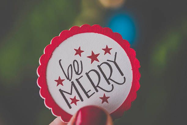istock Handmade holiday message held against defocused Christmas tree 499980296