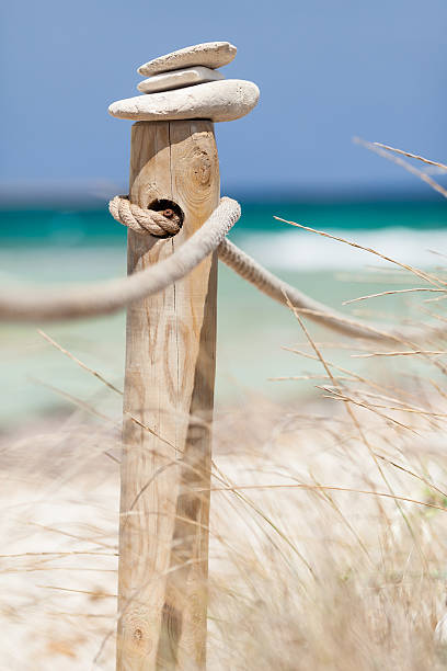 istock Stones balanced on wooden banister. 499980335