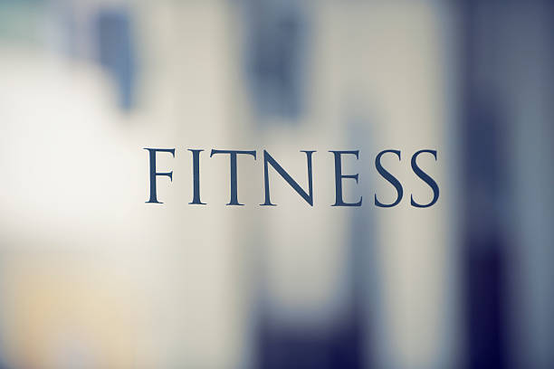 The text on a glass door to the fitness center in a hotel