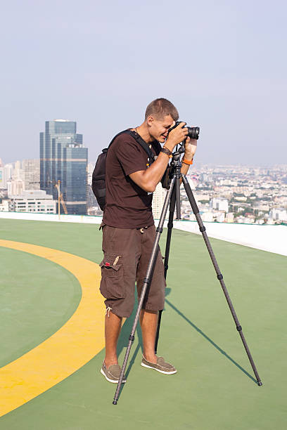 istock Photographer man with professional camera 499983419