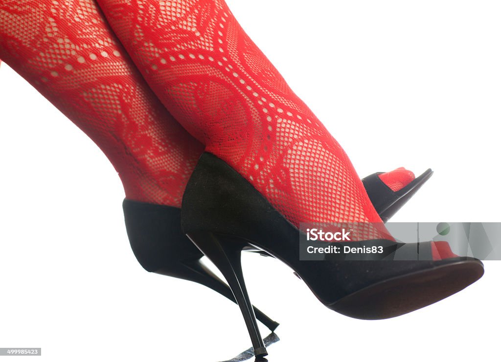 female legs female legs in red stockings and black shoes on white background Adult Stock Photo