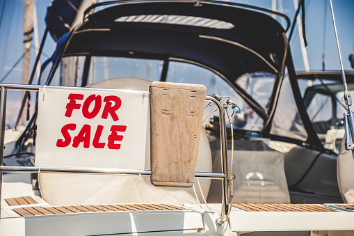 Boat for sale at marina pier.