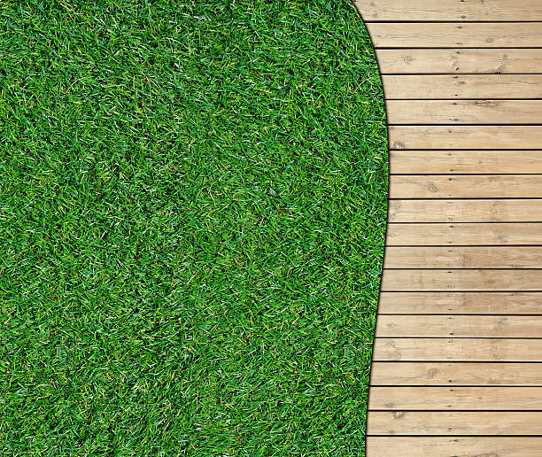 istock Green lawn and wooden floor texture background 499999698