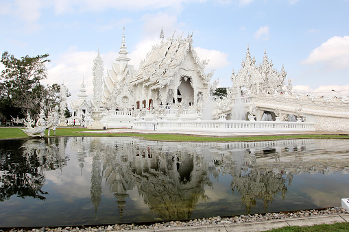 Wat Rong Khun more well-known among foreigners as the White Temple, is a contemporary unconventional Buddhist temple in Chiang Rai Province, Thailand. It was designed by Chalermchai Kositpipat in 1997.