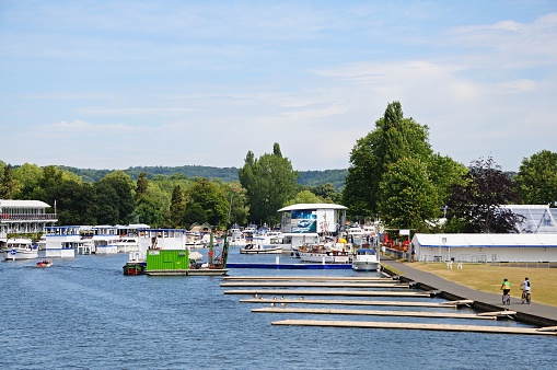 Henley-on-Thames, United Kingdom - July 10, 2015: Henley Regatta moorings alongside the River Thames with people going about their business, Henley-on-Thames, Oxfordshire, England, UK, Western Europe.
