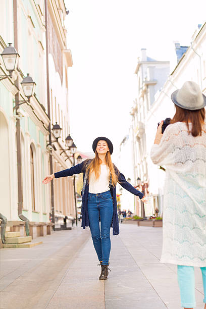istock Girl shooting her friend with professional camera 500003040