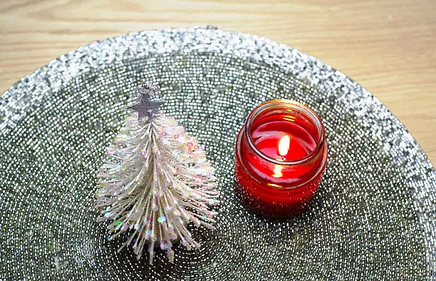e Christmas and red candle on the glitter mat decoration