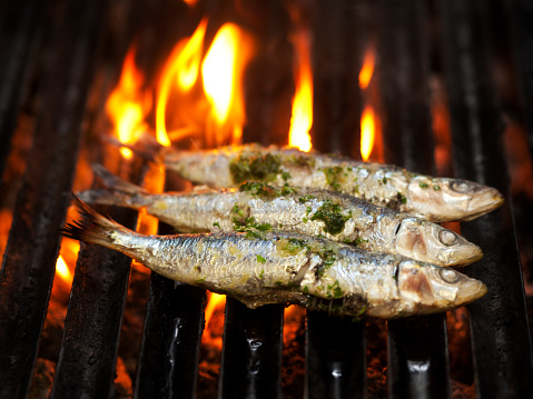 Fresh sardines being grilled on the barbecue 