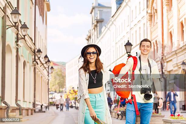 Happy Girl Holds Arm Of Young Man Walking Forward Stock Photo - Download Image Now - Adult, Baby - Human Age, Baby Girls