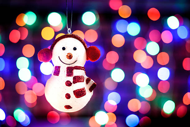 Snowman ornament on the bokeh background