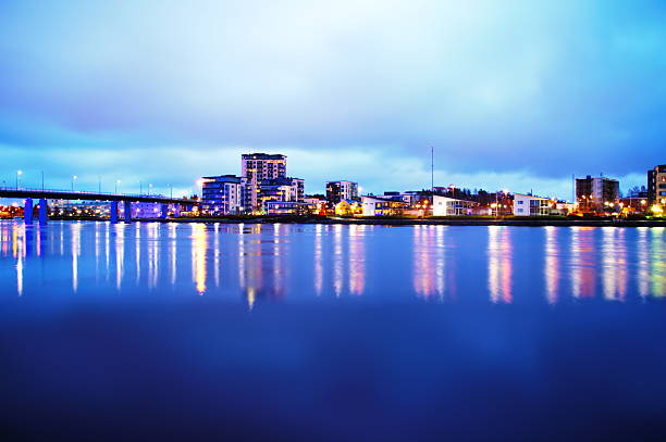 blur reflection city light in water and building at dusk abstract