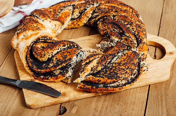 Estonian pastry kringel with poppy seeds on wooden background